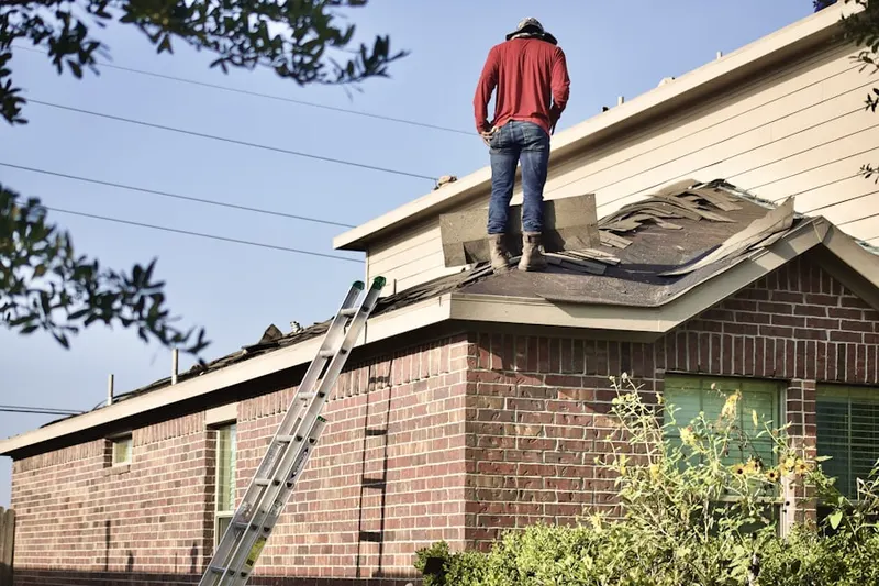 Professional roofer working on a residential roof in Regency Pointe